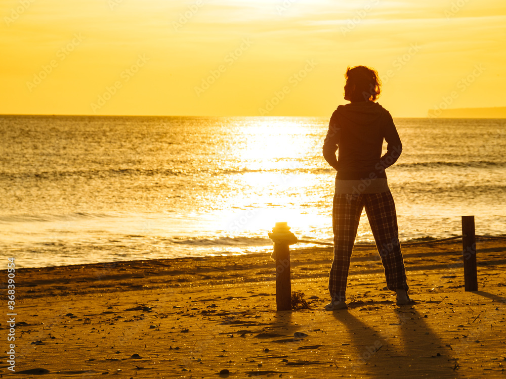 Woman on beach enjoy sunrise