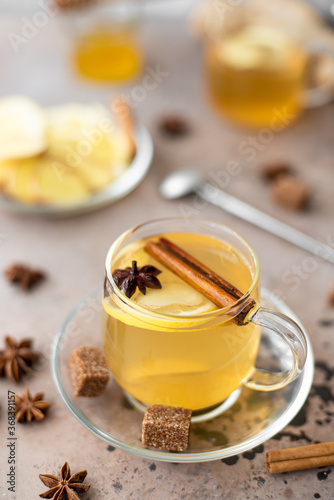 hot herbal tea with lemon, ginger and honey in glass mugs