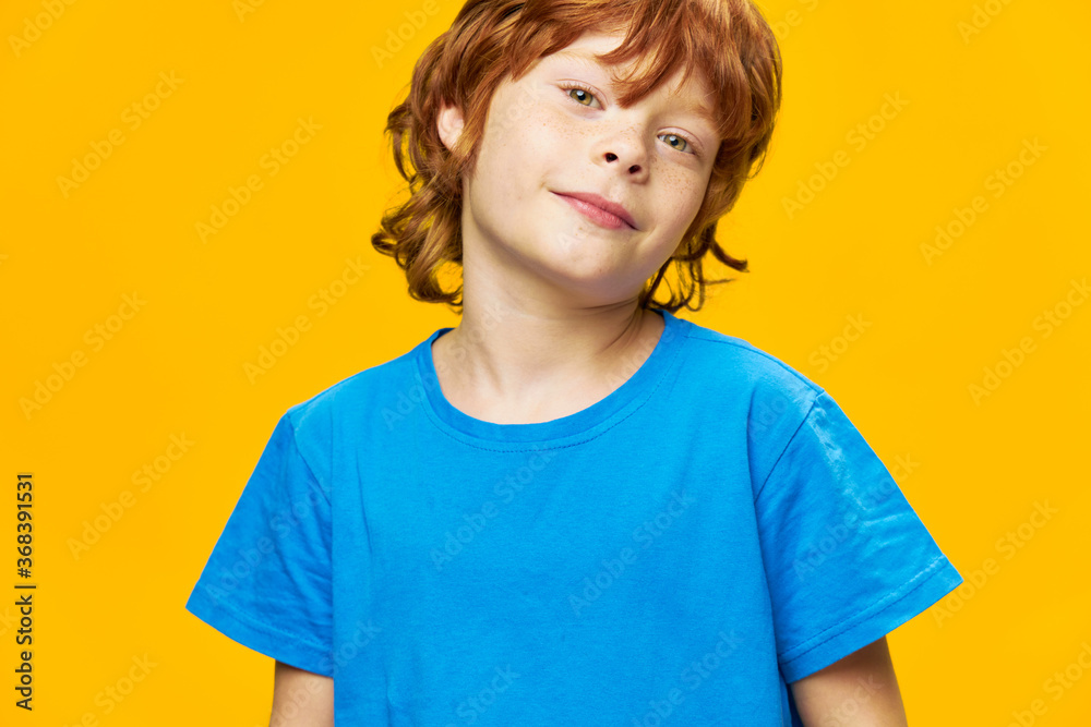 Red hair blue t-shirt yellow background handsome boy Red hair blue t-shirt yellow background handsome boy