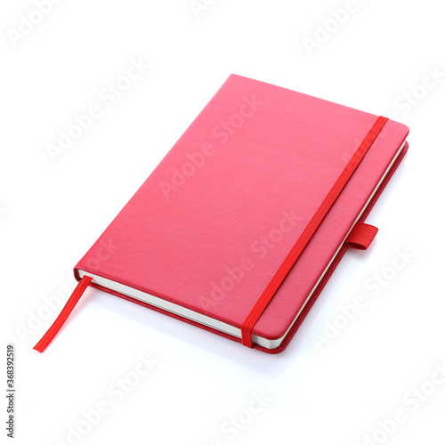 Lush lava red colour leather fabric hardcover notebook with elastic band lay back on white surface. Top view with notebook closed. Isolated on white background. For mockup, branding & advertising.