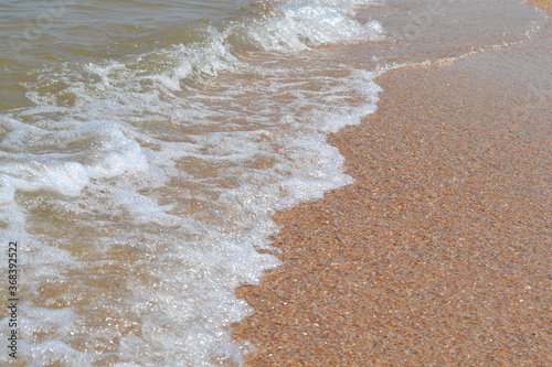 small waves on the black sea beach on a July summer day