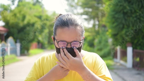   Middle-aged Asian women wearing nose pads before going outside to prevent covid-19.