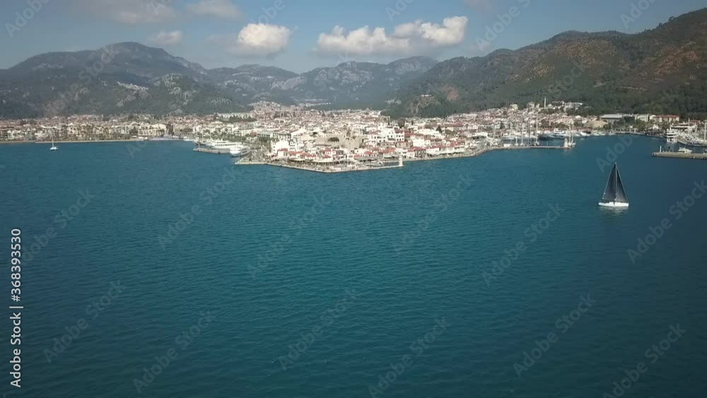 Aerial drone shot of the Marmaris town, quay, old castle and harbour with boats. Drone moving forward from wide view to close view Aerial drone shot of the Marmaris town, quay, old castle and harbour with boats. Drone moving forward from wide view to close view