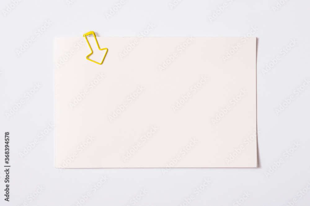 white sheet of paper for notes and paper clip
white sheet of paper for notes and paper clip