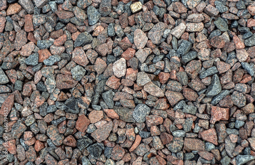texture of red and brown granite stones scattered on the ground
