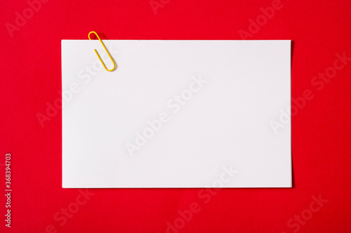 white sheet of paper for notes and paper clip 
