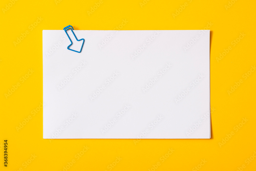 white sheet of paper for notes and paper clip
white sheet of paper for notes and paper clip