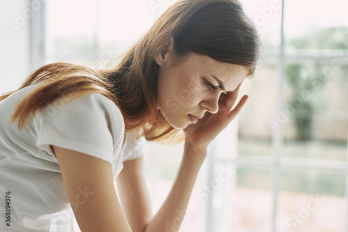 Headache woman at home interior problems migraine 