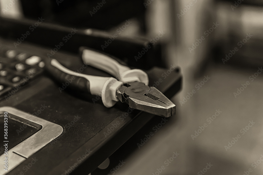 instrument nippers on edge of keyboard touchscreen close-up computer repair instrument nippers on edge of keyboard touchscreen close-up computer repair