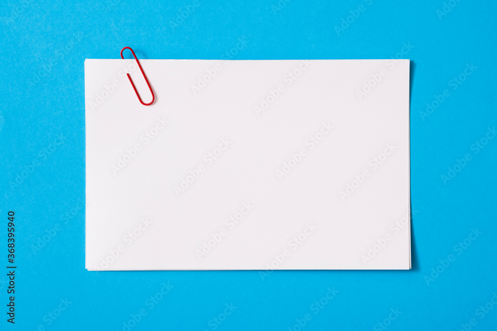 white sheet of paper for notes and paper clip
white sheet of paper for notes and paper clip
