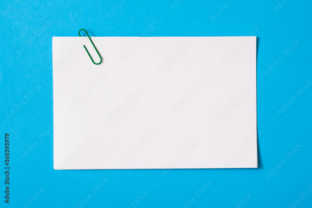 white sheet of paper for notes and paper clip
 - obrazy, fototapety, plakaty 