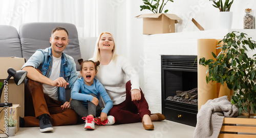 concept housing a young family. Mother father and child in new house with a roof at a home © Angelov