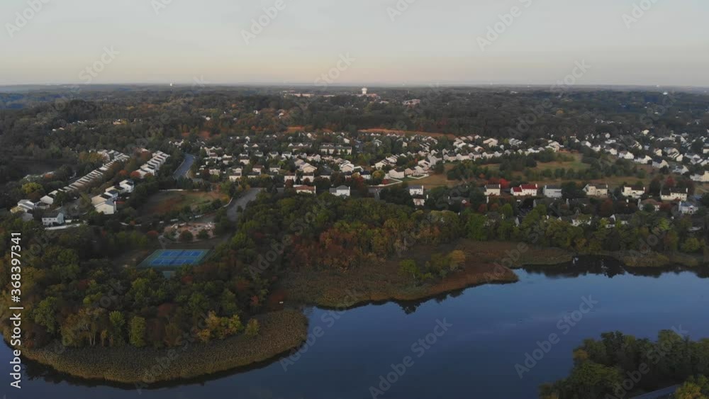 Aerial view of a town along the river with residential areas of private houses bench in autumn landscape Aerial view of a town along the river with residential areas of private houses bench in autumn landscape