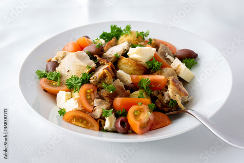 Grilled chicken salad with olives, feta cheese and tomatoes