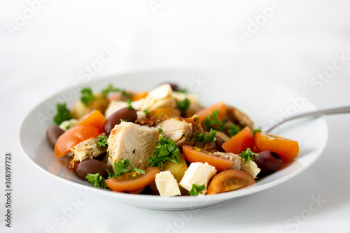 Grilled chicken salad with olives, feta cheese and tomatoes