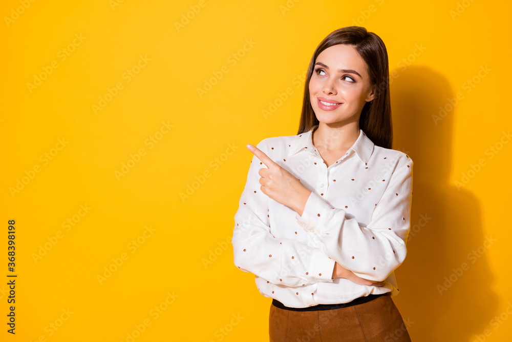 Portrait of her she nice-looking attractive lovely pretty cute cheerful cheery brown-haired girl showing copy space advert advice isolated bright vivid shine vibrant yellow color background