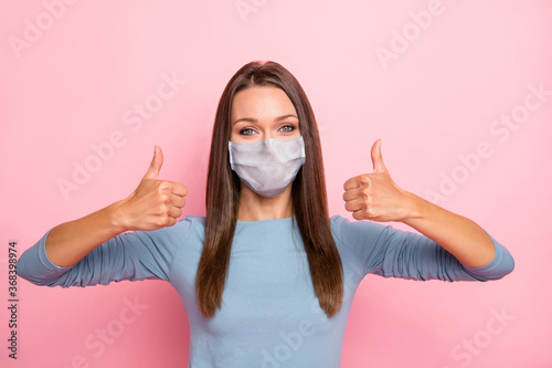 Close-up portrait of her she nice attractive pretty healthy girl wearing safety mask showing two double thumbup influenza pandemia recovery therapy isolated over pink pastel color background photo