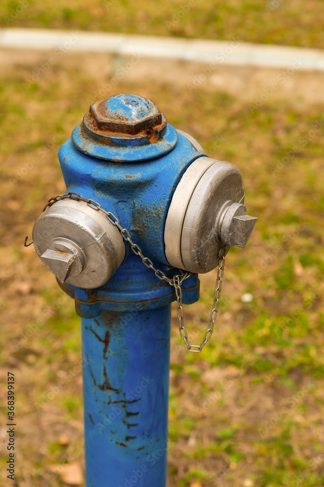Blue hydrant on a green field. Summer sunny day. Blue hydrant on a green field. Summer sunny day.