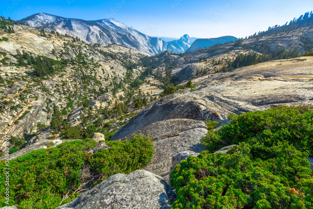 Panorama of Olmsted Point, off Tioga Pass Road in Yosemite National Park, California, United States. Clouds Rest is on the left, Half Dome is on the right and Tenaya Canyon between them.
