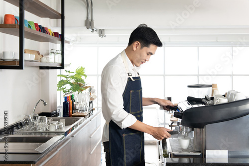 Asian barista man standing to make hot coffee in a cafe shop, working in the happiness beverage workplace
