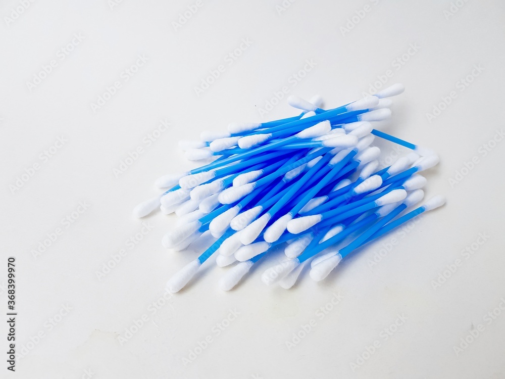 Ear sticks with blue plastic on a white background. Personal hygiene and self-care. Cosmetology and medicine. Ear sticks with blue plastic on a white background. Personal hygiene and self-care. Cosmetology and medicine.