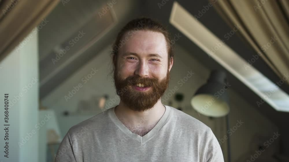 portrait of freelancer bearded man smiling at home Spbd. happy caucasian male with joyful expression. handsome man in home office teleworking, looking at camera portrait of freelancer bearded man smiling at home Spbd. happy caucasian male with joyful expression. handsome man in home office teleworking, looking at camera