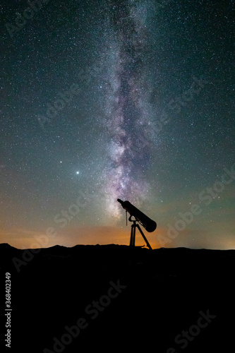 milky way and starry sky with telescope