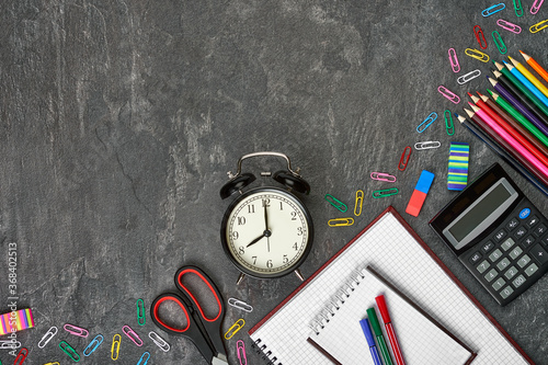 Colorful school supplies over wooden desktop. Back to school concept