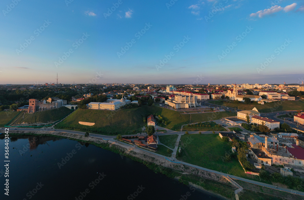 Panoramic view of the city of Grodno, the embankment, the Neman river and the old city. Autumn evening, the city in the sunshine against a background the blue sky.
