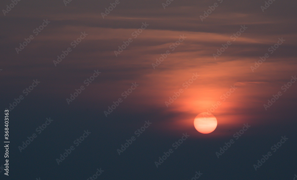 Final moments of a beautiful sunset. Sun is about to set and it spreads its colours to the sky making it vibrant. Final moments of a beautiful sunset. Sun is about to set and it spreads its colours to the sky making it vibrant.