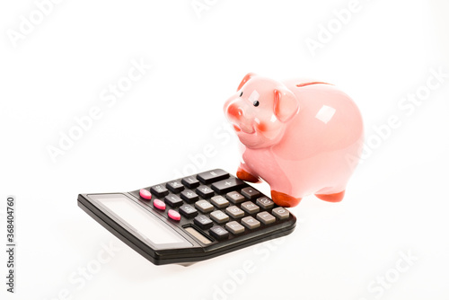 Piggy bank money savings. Piggy bank pig and calculator. Credit debt concept. Economics and profit management. Economics and finance. Investing gain profit. Economics and business administration