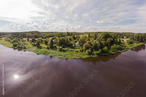 Magnificent panorama from a high point on the river, forest and beautiful sky on a Sunny day.