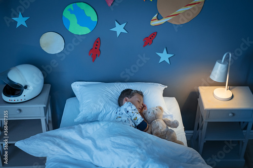 Boy sleeping and dreaming a future in the space