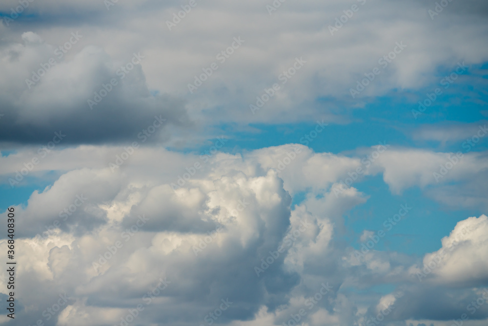Fluffy clouds in front of a blue sky Fluffy clouds in front of a blue sky