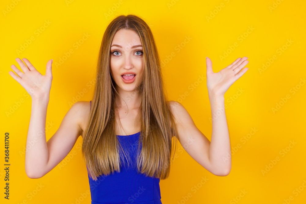 Achievement, success concept. Cheerful female raising her hands up, having eyes full of happiness rejoicing her great achievements. Attractive caucasian female dressed formally. Achievement, success concept. Cheerful female raising her hands up, having eyes full of happiness rejoicing her great achievements. Attractive caucasian female dressed formally.