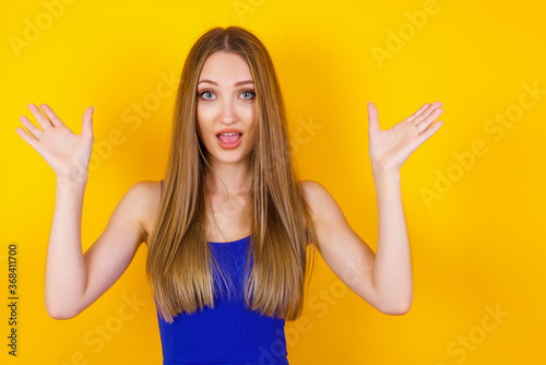 Achievement, success concept. Cheerful female raising her hands up, having eyes full of happiness rejoicing her great achievements. Attractive caucasian female dressed formally.