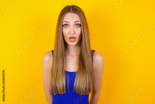Attractive young woman having stunned and shocked look, with mouth open and jaw dropped, listening to friend's story in full disbelief, exclaiming: Wow, I can't believe this. Surprised girl. Shock