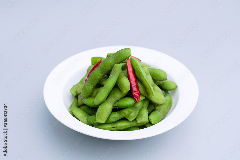 A traditional Chinese delicacy in solid color, boiled soybeans in brine. Chinese traditional food boiled soybean A traditional Chinese delicacy in solid color, boiled soybeans in brine. Chinese traditional food boiled soybean