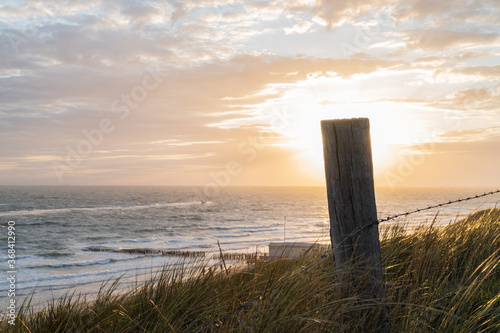 Photograph at the beach and dunes moments before the sun sets in the southwest of the Netherlands.  photo