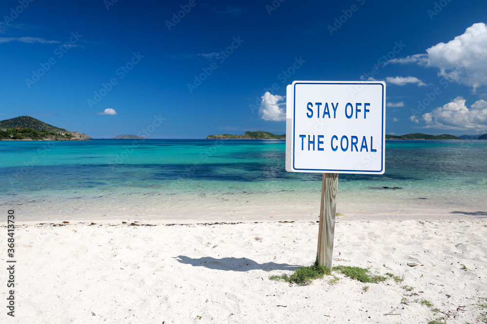 on wood board sign stay off the coralson the beautiful beach with colorful clear water in Caribbean sea on wood board sign stay off the coralson the beautiful beach with colorful clear water in Caribbean sea