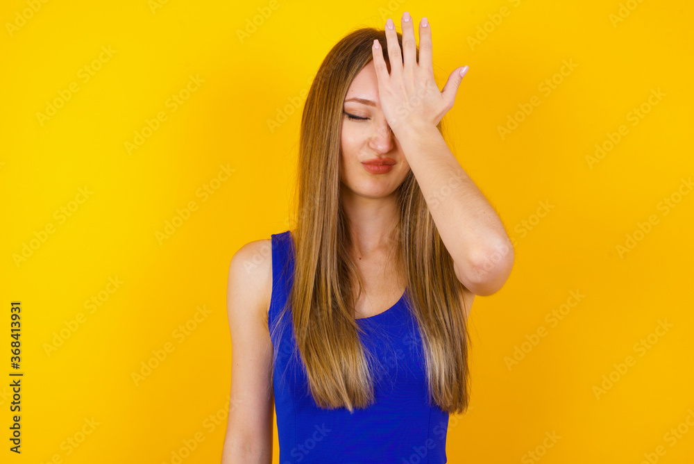 Frustrated brunette woman wearing casual clothes holding hand on forehead, frowning her face, being depressed having headache. Frustrated brunette woman wearing casual clothes holding hand on forehead, frowning her face, being depressed having headache.