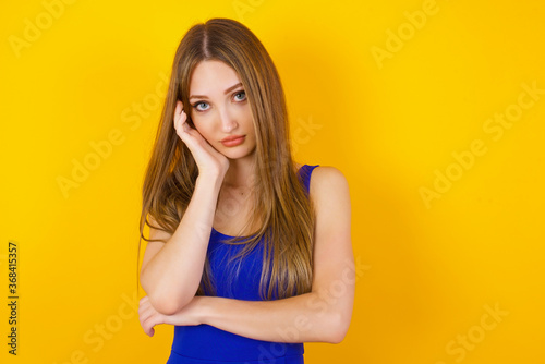 Gloomy young sad asian blond girl sighing upset stoop look from under forehead lonely unhappy lean palm bored feel regret sadness moody expression standing white background pessimistic