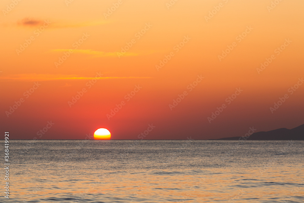 sunset with yachts on santorini island