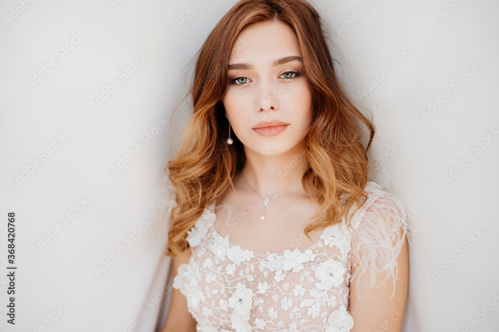 beautiful bride in white dress on background of white cloth beautiful bride in white dress on background of white cloth
