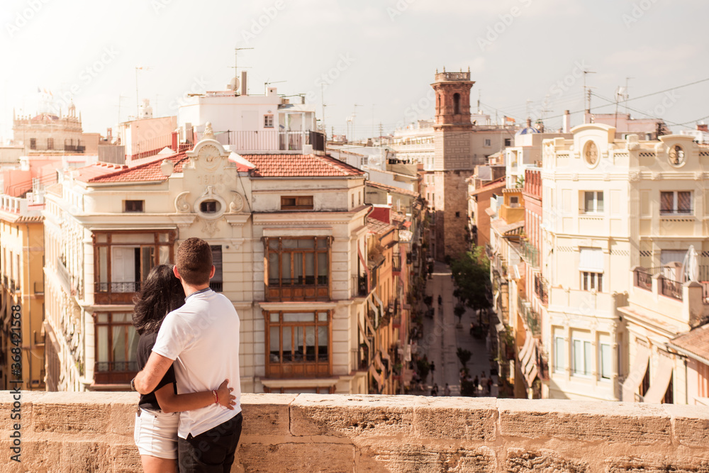Pretty couple enjoying the views of the city center of Valencia from above on a sunny summer day