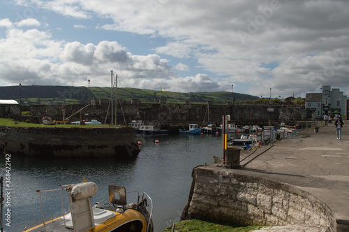 A harbor in Northern Ireland filled with boats  looking out to sea.