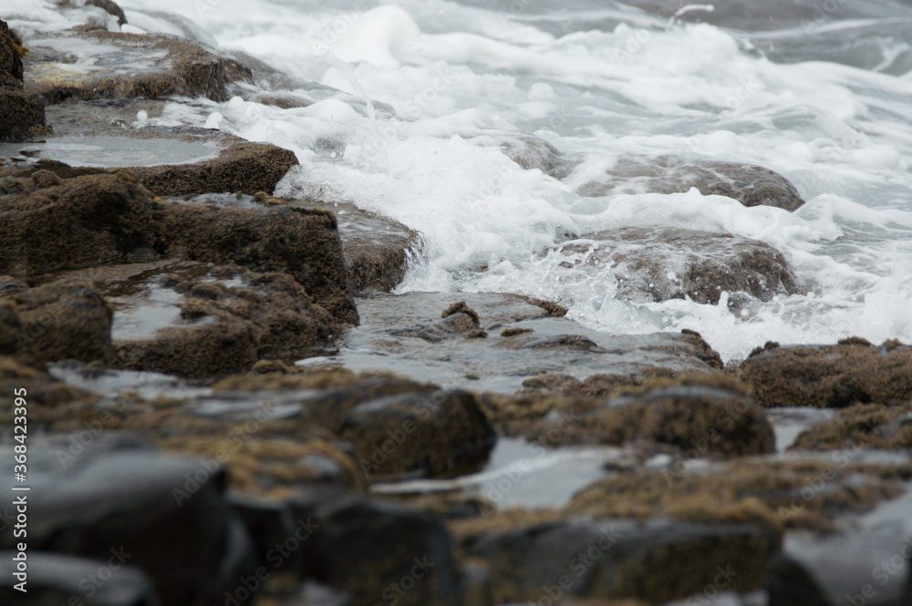 Waves crashing against rocks at the Giant's Causeway, Northern Ireland. Waves crashing against rocks at the Giant's Causeway, Northern Ireland.