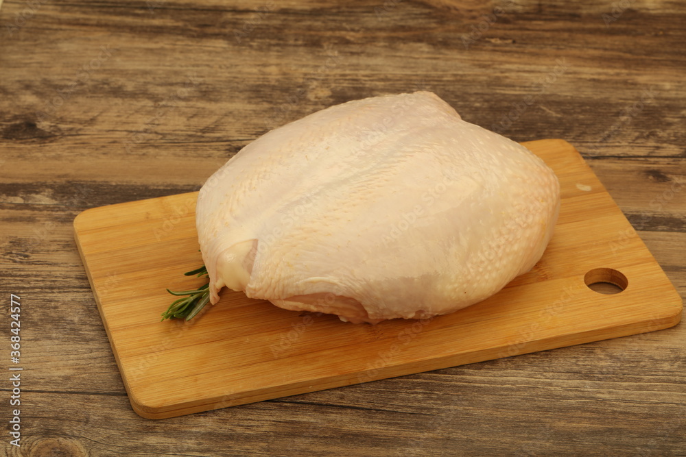 Raw whole chicken breast with skin Raw whole chicken breast with skin