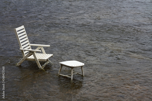 background chairs are set in water streams for relaxation.