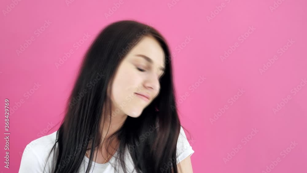 Beautiful brunette girl lifestyle video concepts. Attractive blue-eyed girl posing on colored backgrounds 4k